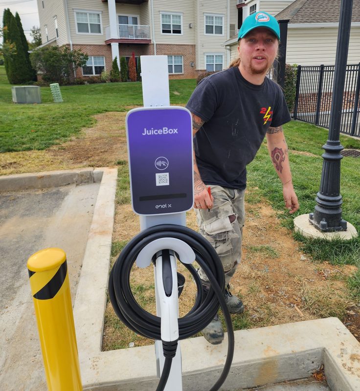 Tyler Moorhead of 2 Live Wires installing a JuiceBox EV charger at a Lehigh Valley home